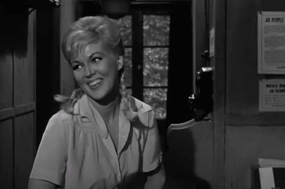 Cynthia Lynn as  Fraulein Helga in white shirt