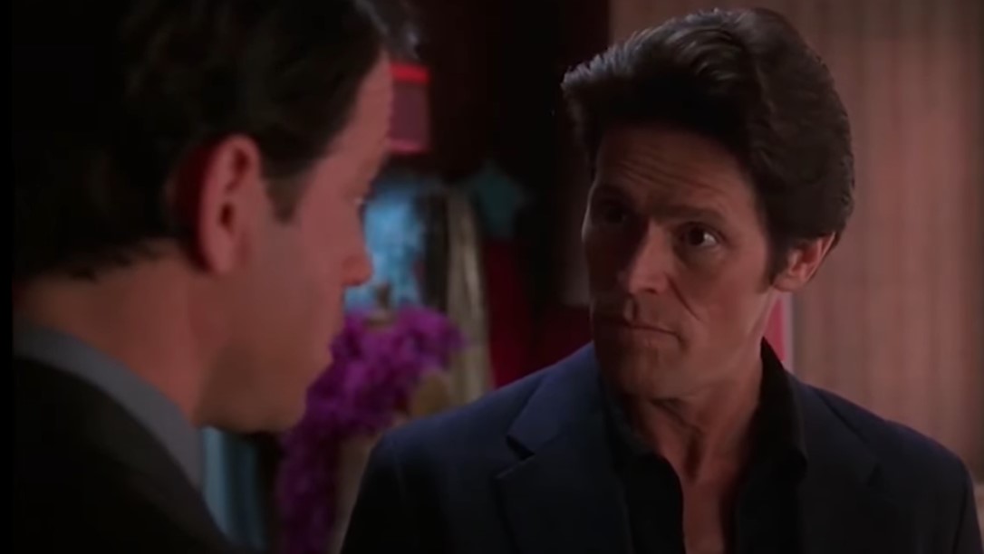 Willem Dafoe  as John Carpenter and Greg Kinnear  as  Bob Crane speaking to each other