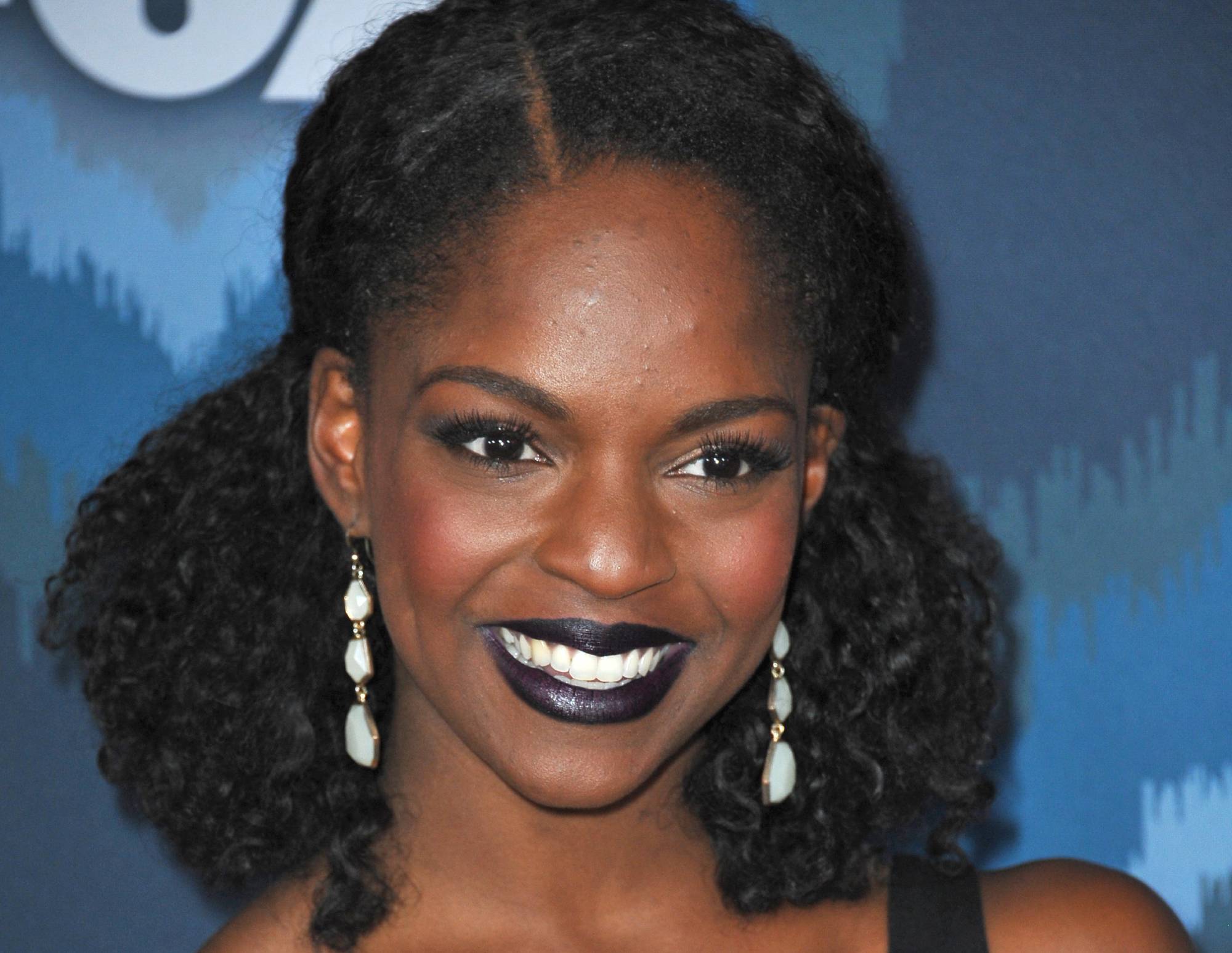 Samantha Marie Ware in black top and earrings