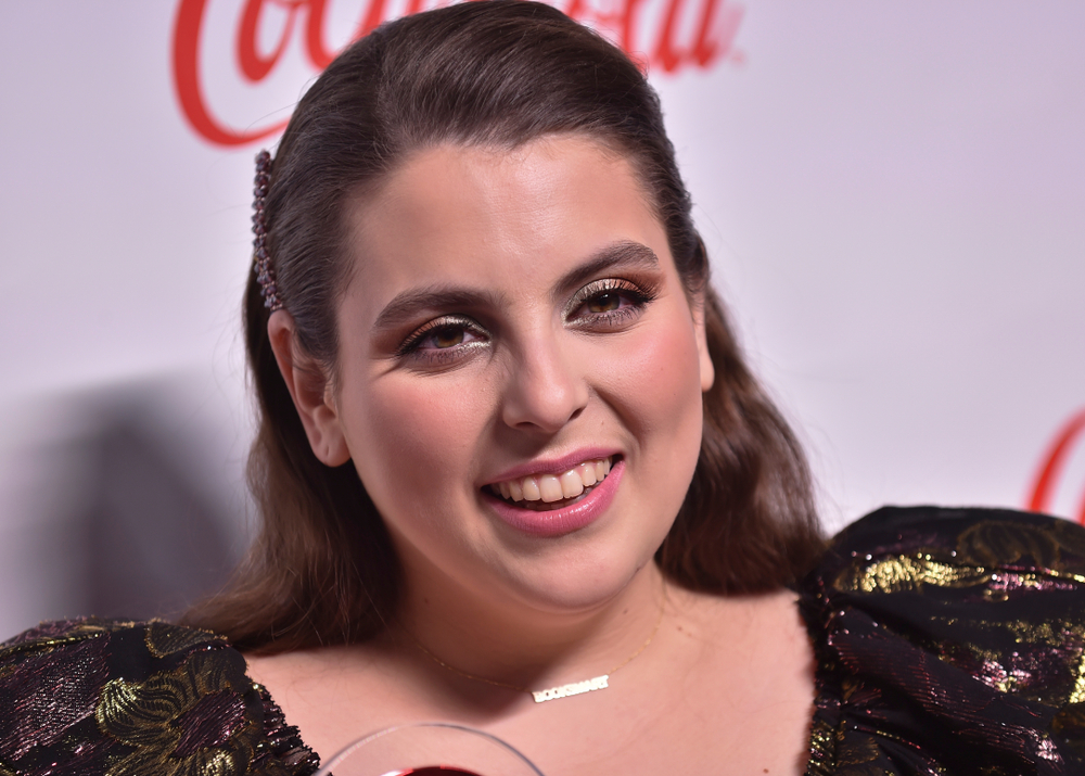Beanie Feldstein in black dress and jewels
