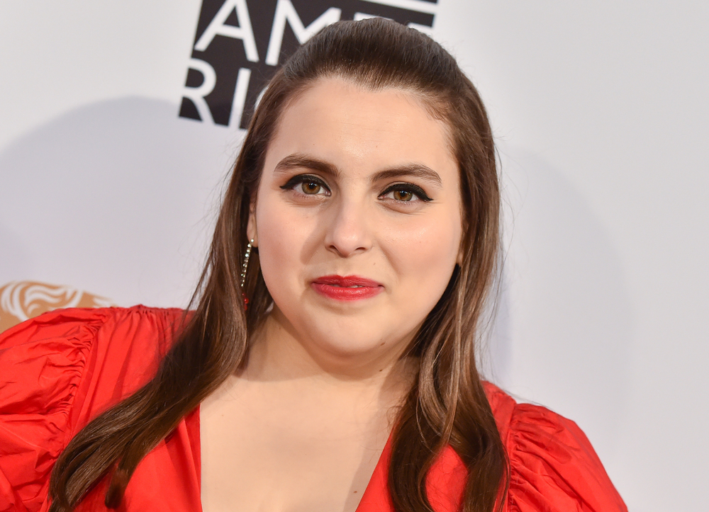 Beanie Feldstein in red dress and earrings