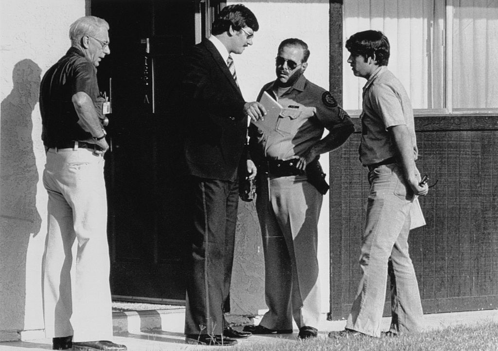 Police gather outside the apartment where actor Bob Crane was beat to death