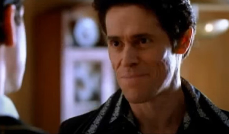 Willem Dafoe  as John Carpenter in black suit