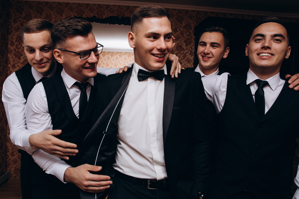 Guys at  a bachelor party in  black suits