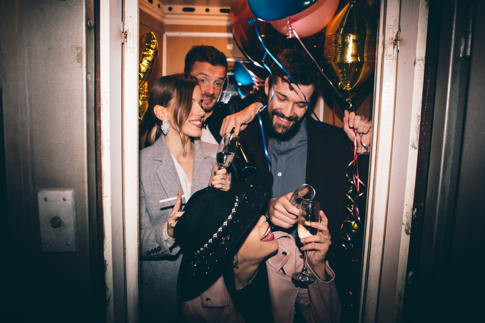 Friends in elevator going to the party