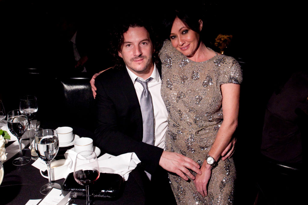 Photographer Kurt Iswarienko (L) and actor Shannen Doherty attend the GQ Gentlemen's Ball in formal wear sitting at table