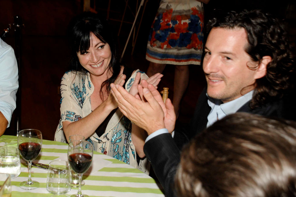 Shannen Doherty and Kurt Iswarienko at event sitting at a table looking at each other