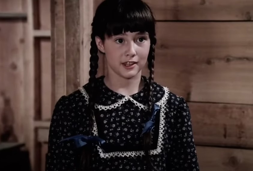 Shannen Doherty as a little girl in  Little House on the Prairie wearing black dress