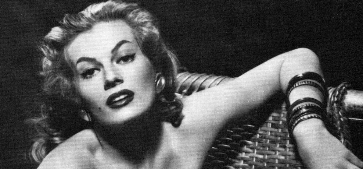 Anita Ekberg wearing earrings sitting on an armchair