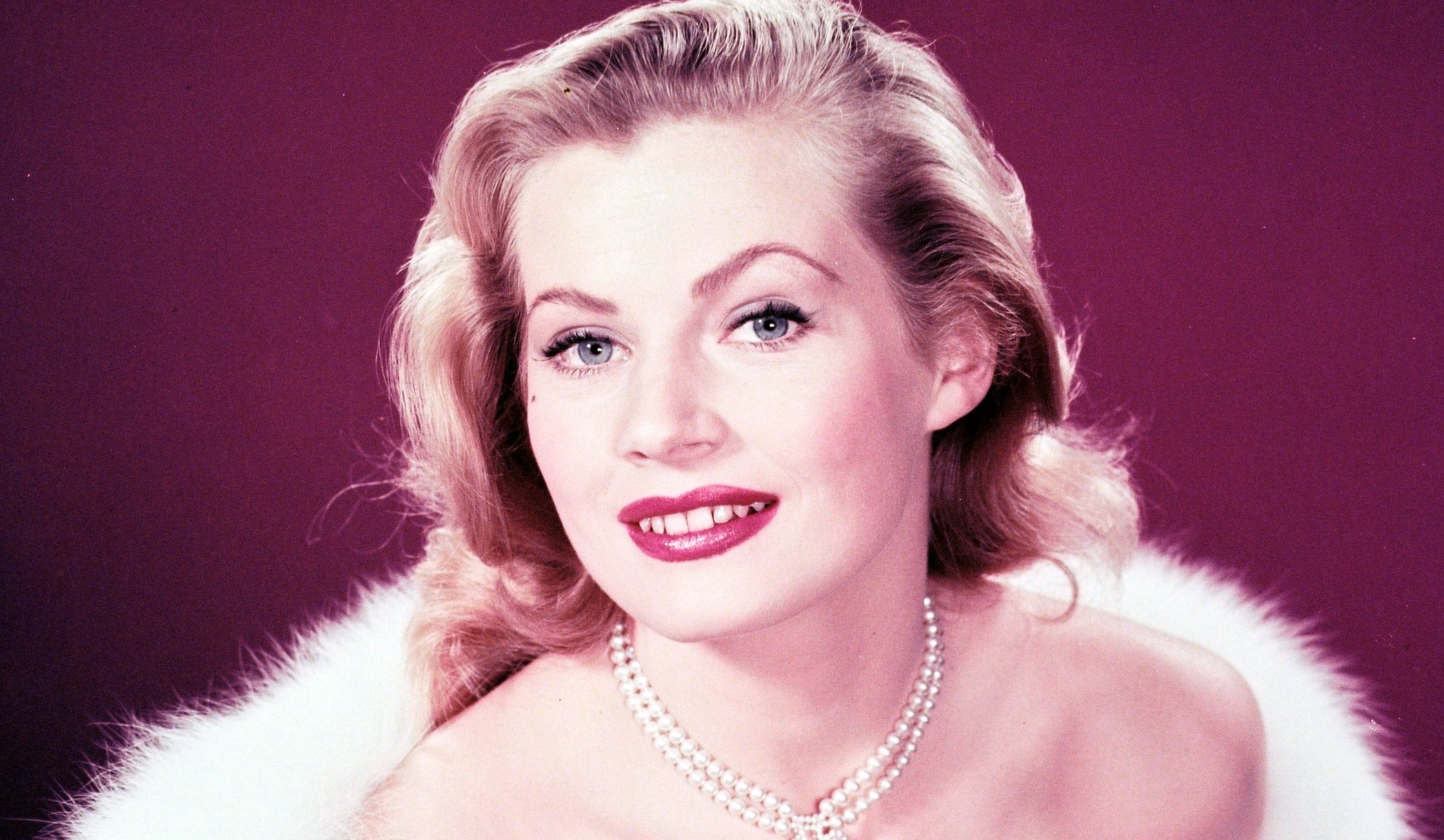 Anita Ekberg, Swedish model and actress, glamorous in a low-cut dress and fur coat