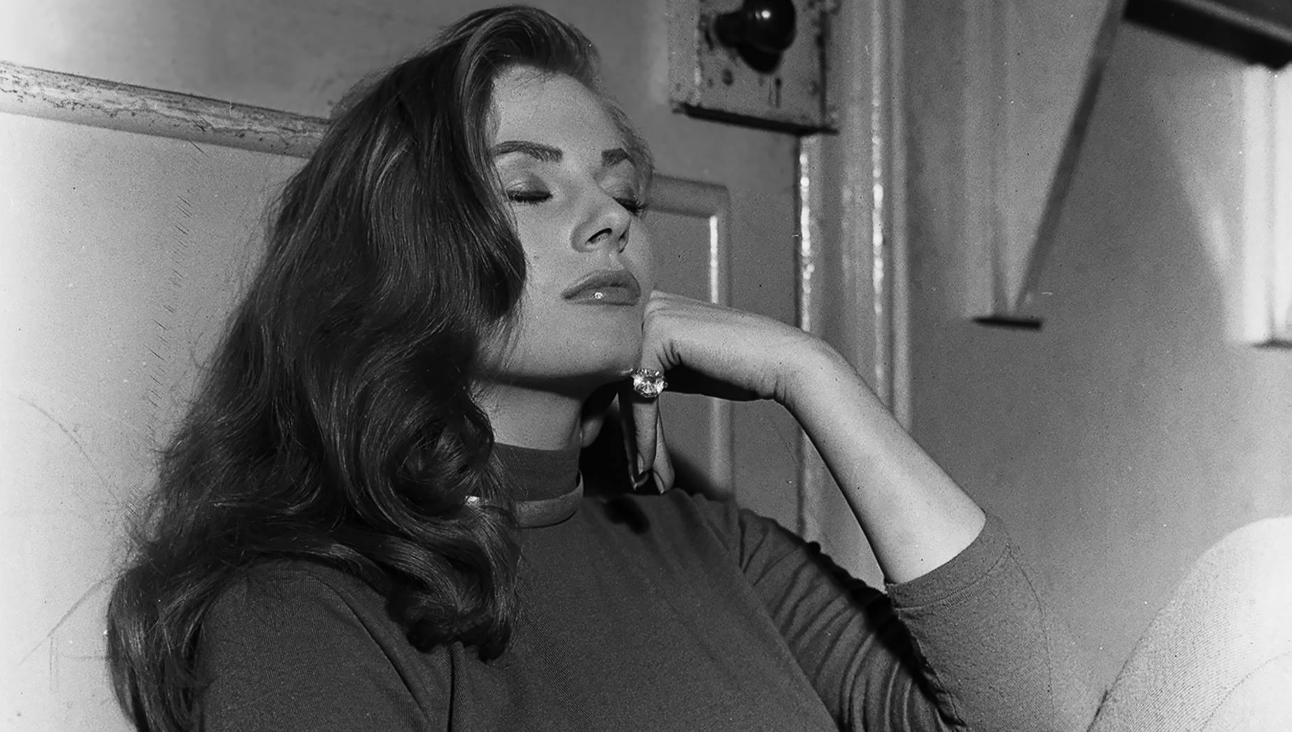 Actress Anita Ekberg sitting on floor December 1955