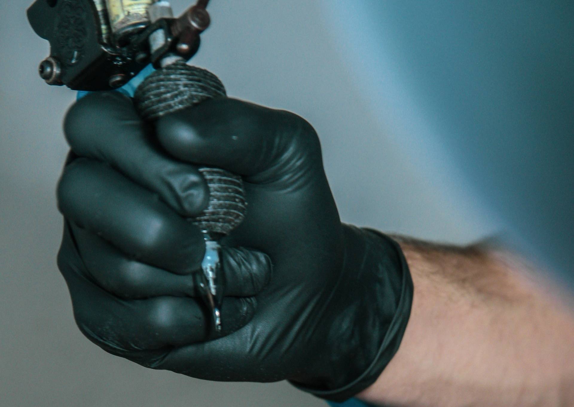 a person holding a tattoo pen