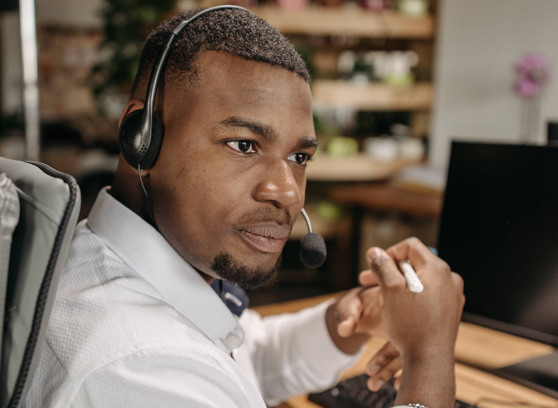 a man in white shirt wearing headphones at work