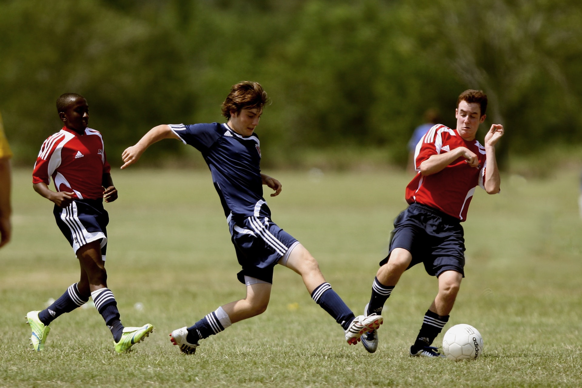 students from two teams playing football