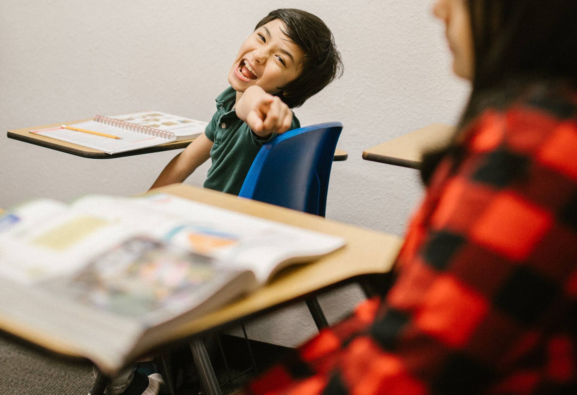 Kid in green t-shirt laughing