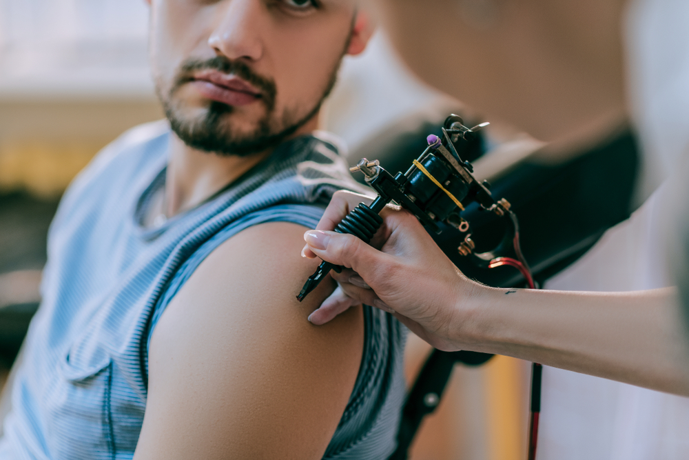 tattoo artist gently touching skin