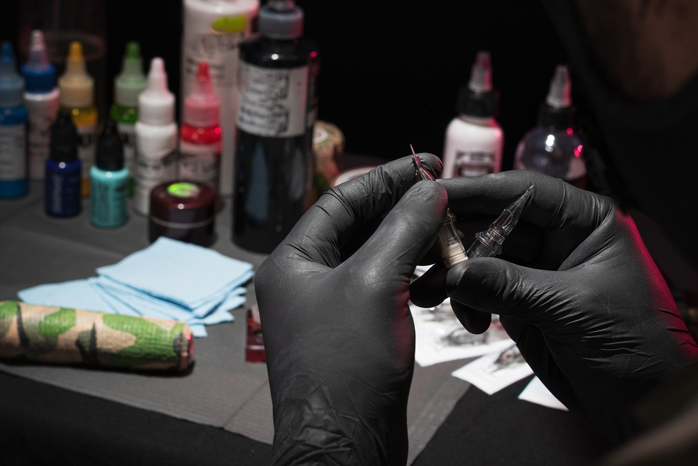 Tattoo artist preparing equipment