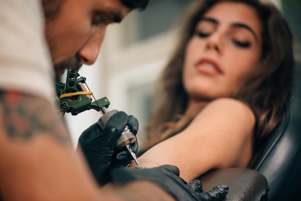 Tattoo artist creating a tattoo