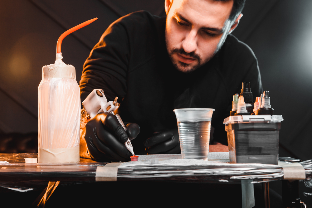 tattoo artist prepares tools