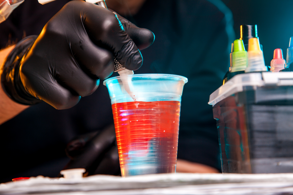 master tattoo artist prepares tools for tattooing