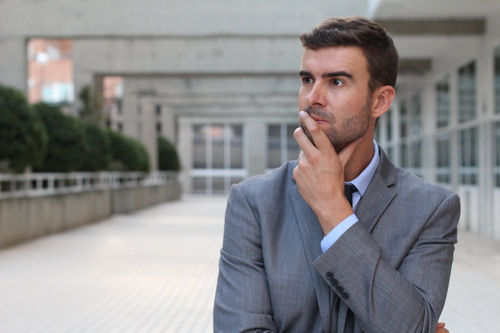 Man in suit realized something an is confused about it