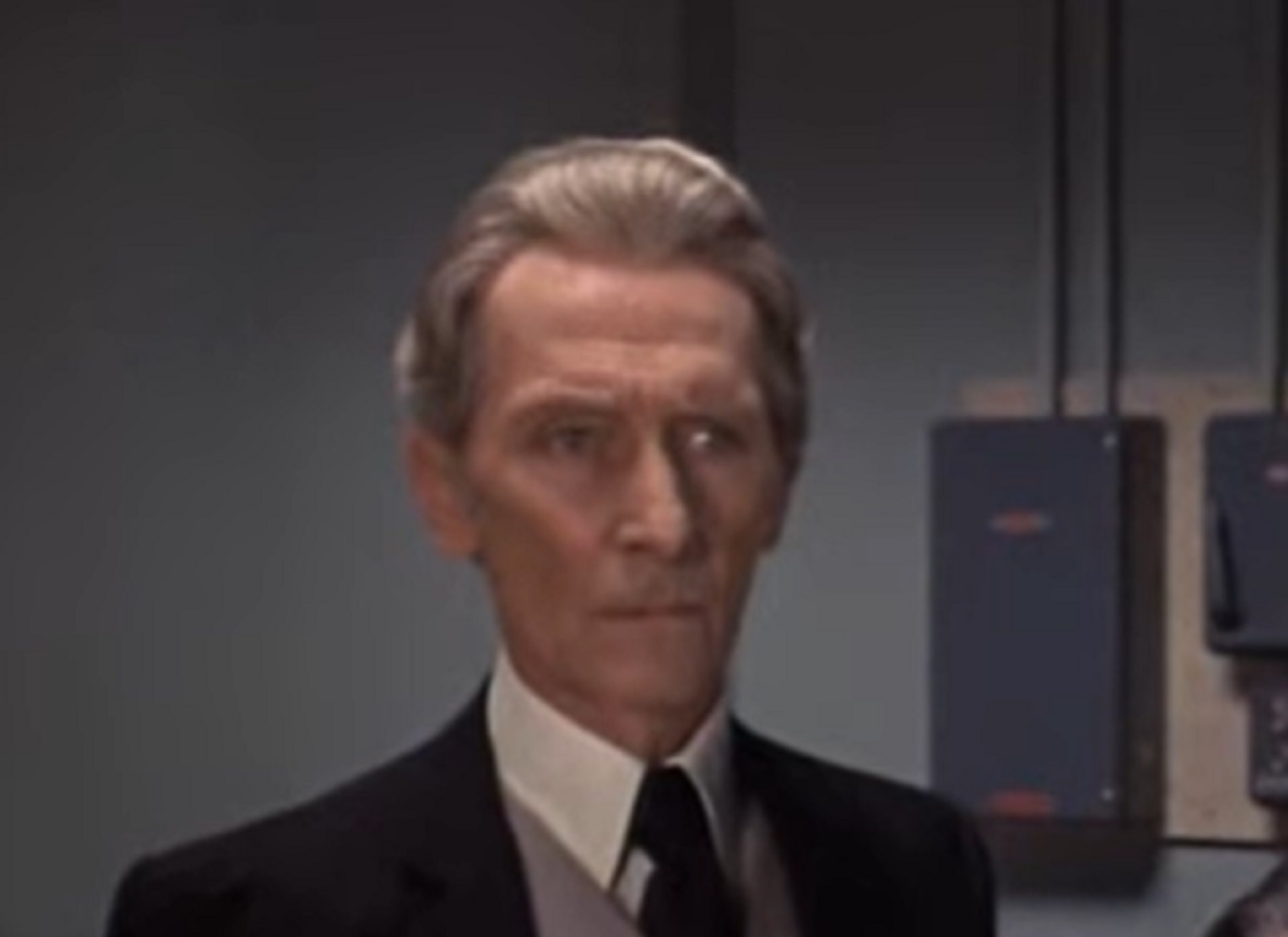 Screenshot of Peter Cushing wearing suit and looking sad - from Nothing But the Night (1973)