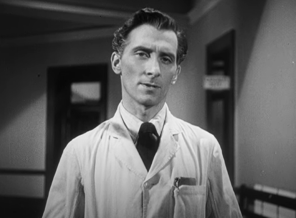 Screenshot of Peter Cushing looking at camera with sad face - from It Might Be You (1946)