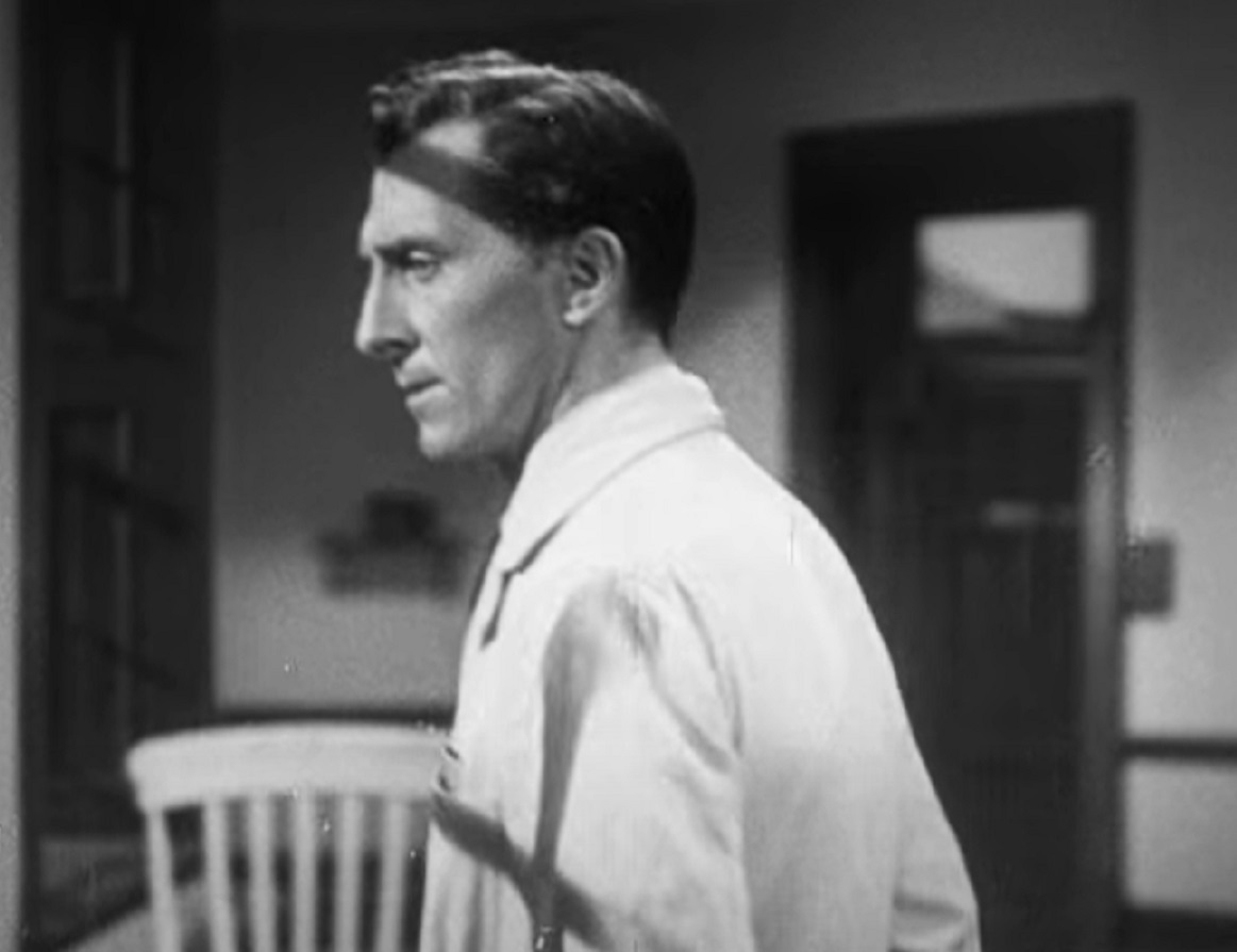 Screenshot of Peter Cushing in white coat is looking at side - from It Might Be You (1946)