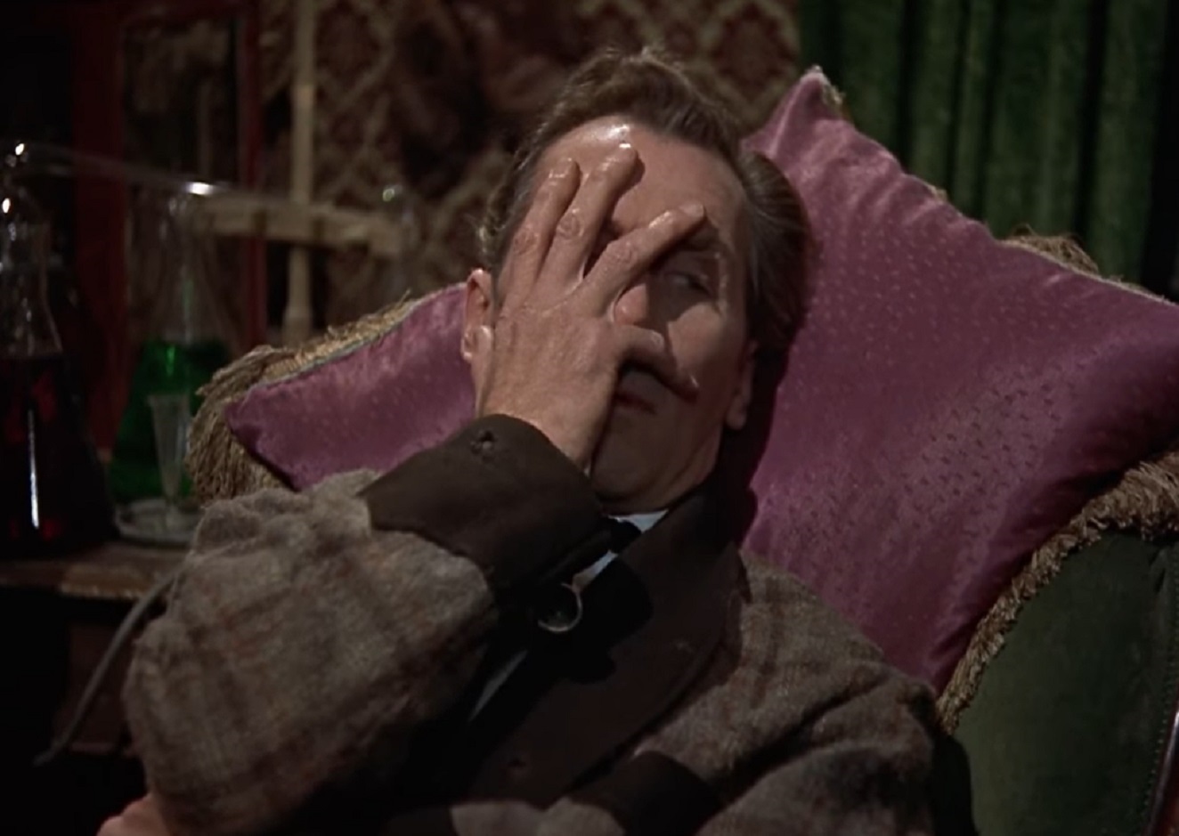 Screenshot of Peter Cushing seating with sad face - from The Hound of the Baskervilles (1959)