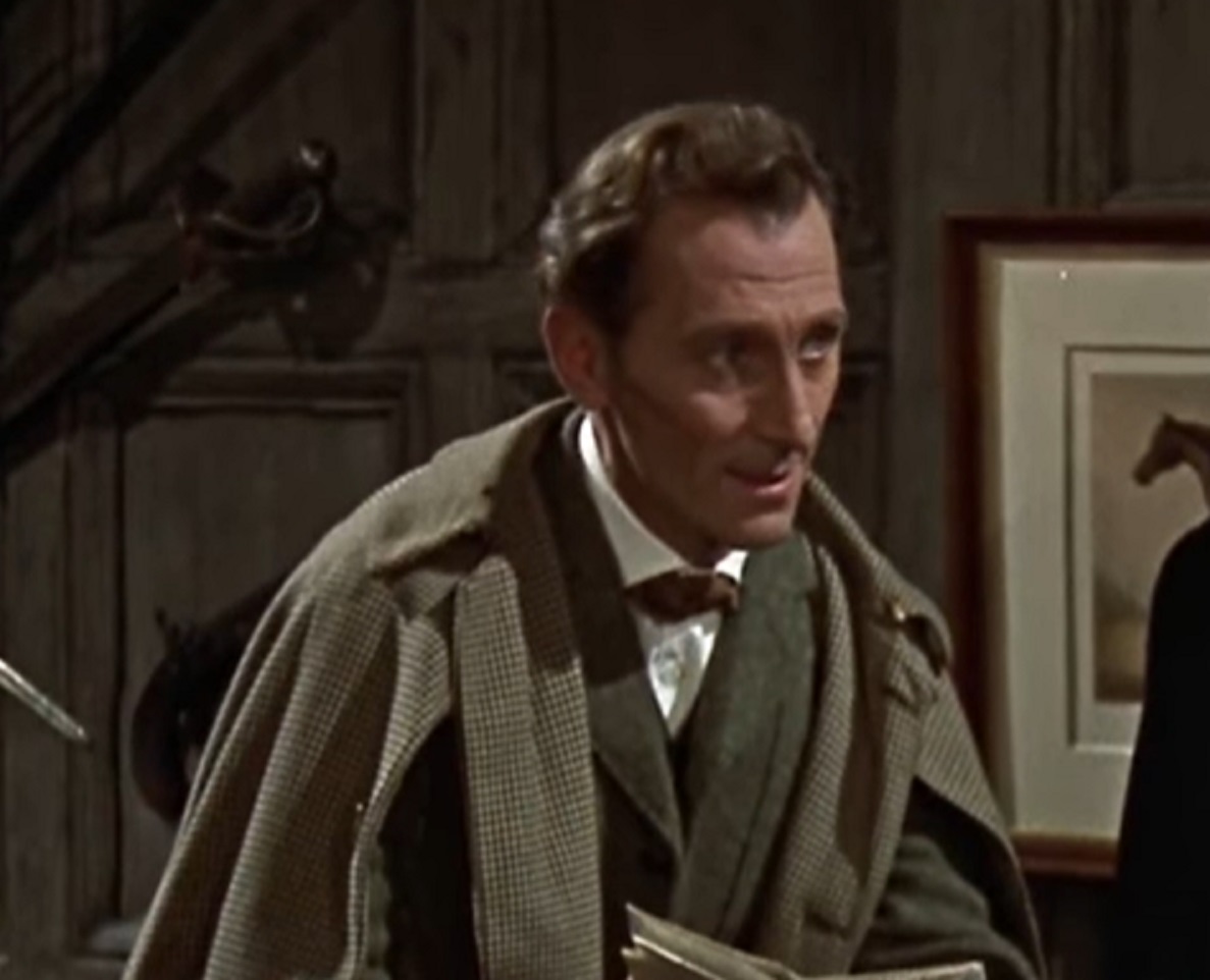 Screenshot of Peter Cushing in green coat is looking at side - from The Hound of the Baskervilles (1959)