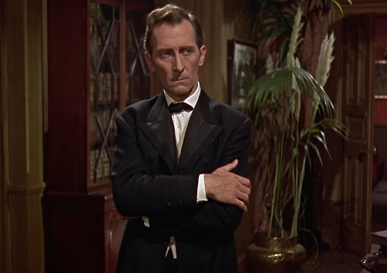 Screenshot of Peter Cushing wearing black suit ,looking sad - from The Hound of the Baskervilles (1959)