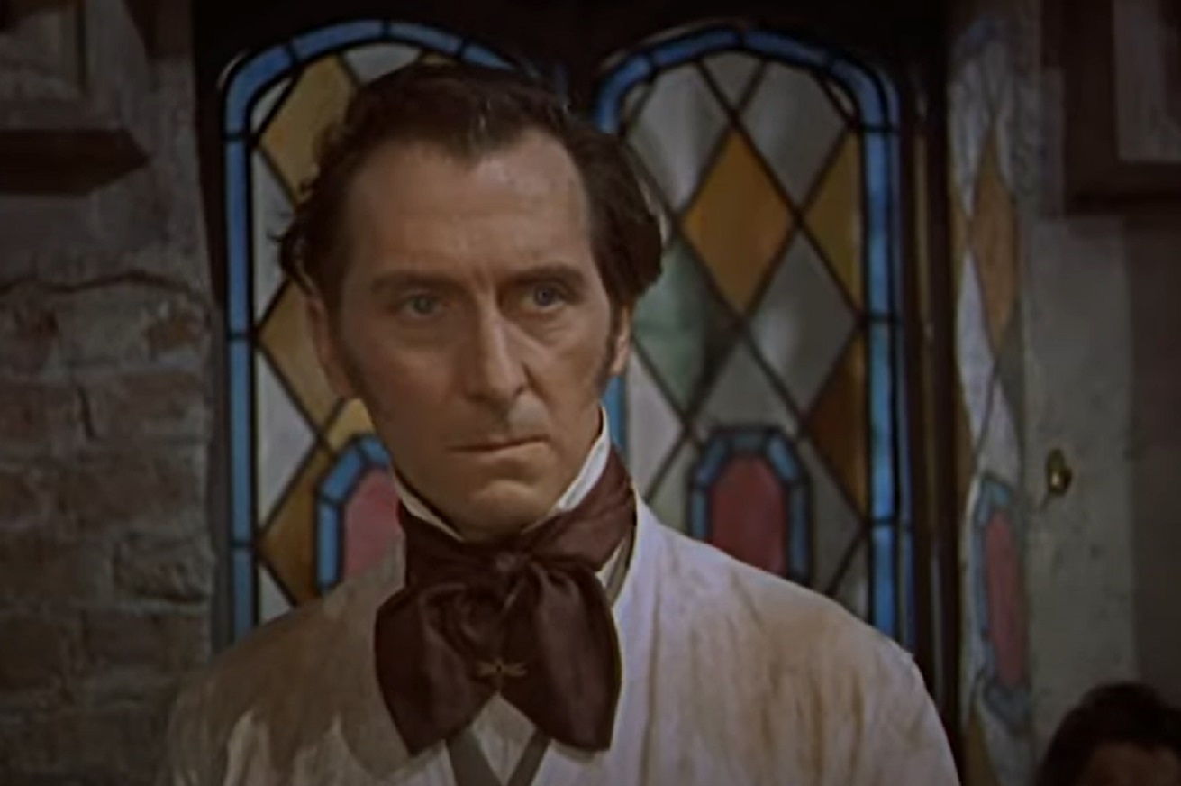 Screenshot of Peter Cushing in white suit is looking at side - from The Revenge Of Frankenstein (1958)