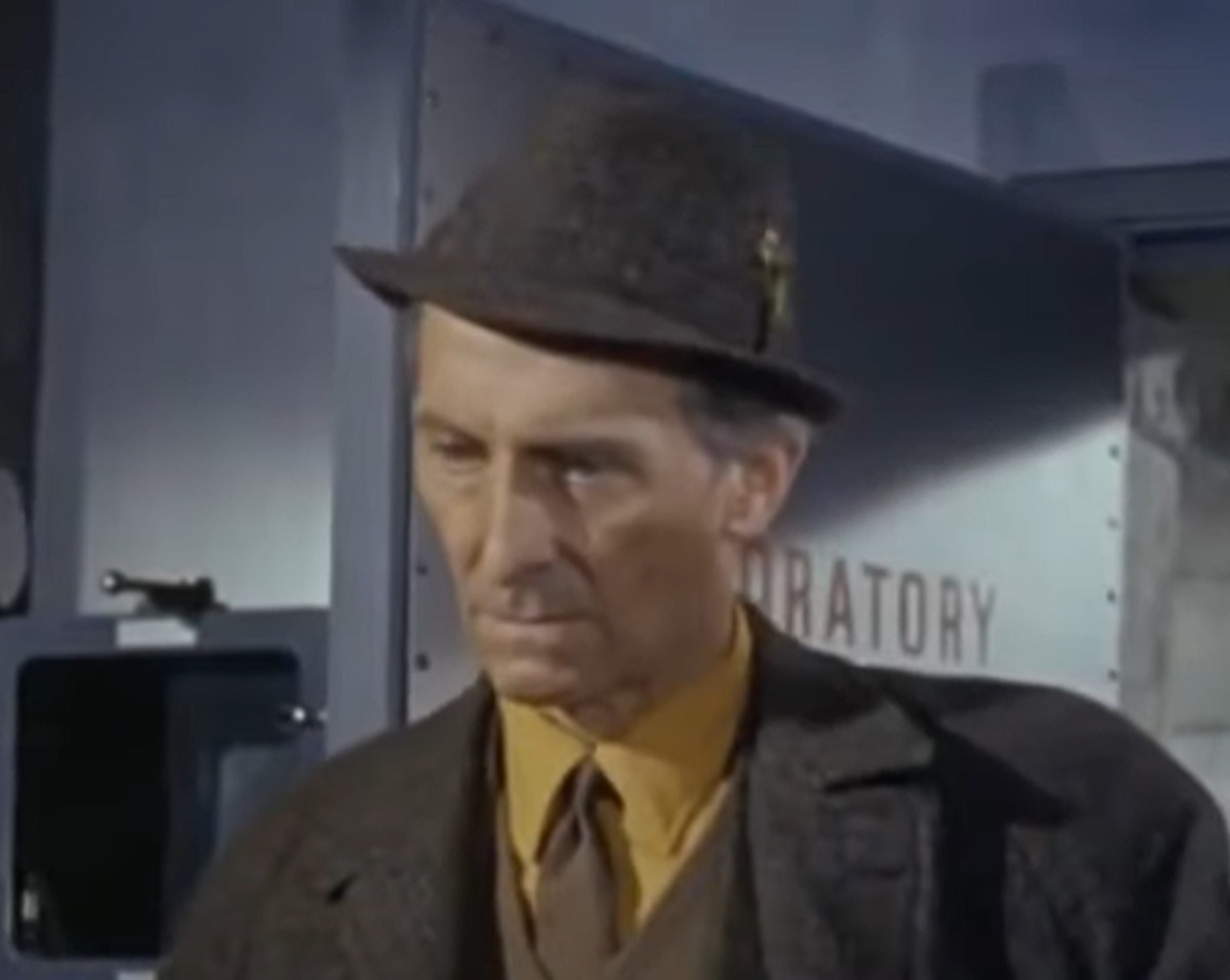 Screenshot of Peter Cushing wearing yellow shirt and hat is looking down - from Island of Terror (1966)