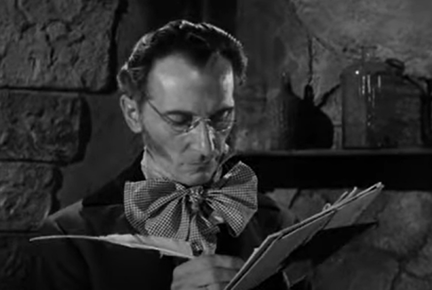 Screenshot of Peter Cushing writing a note - from The Flesh and the Fiends (1960)