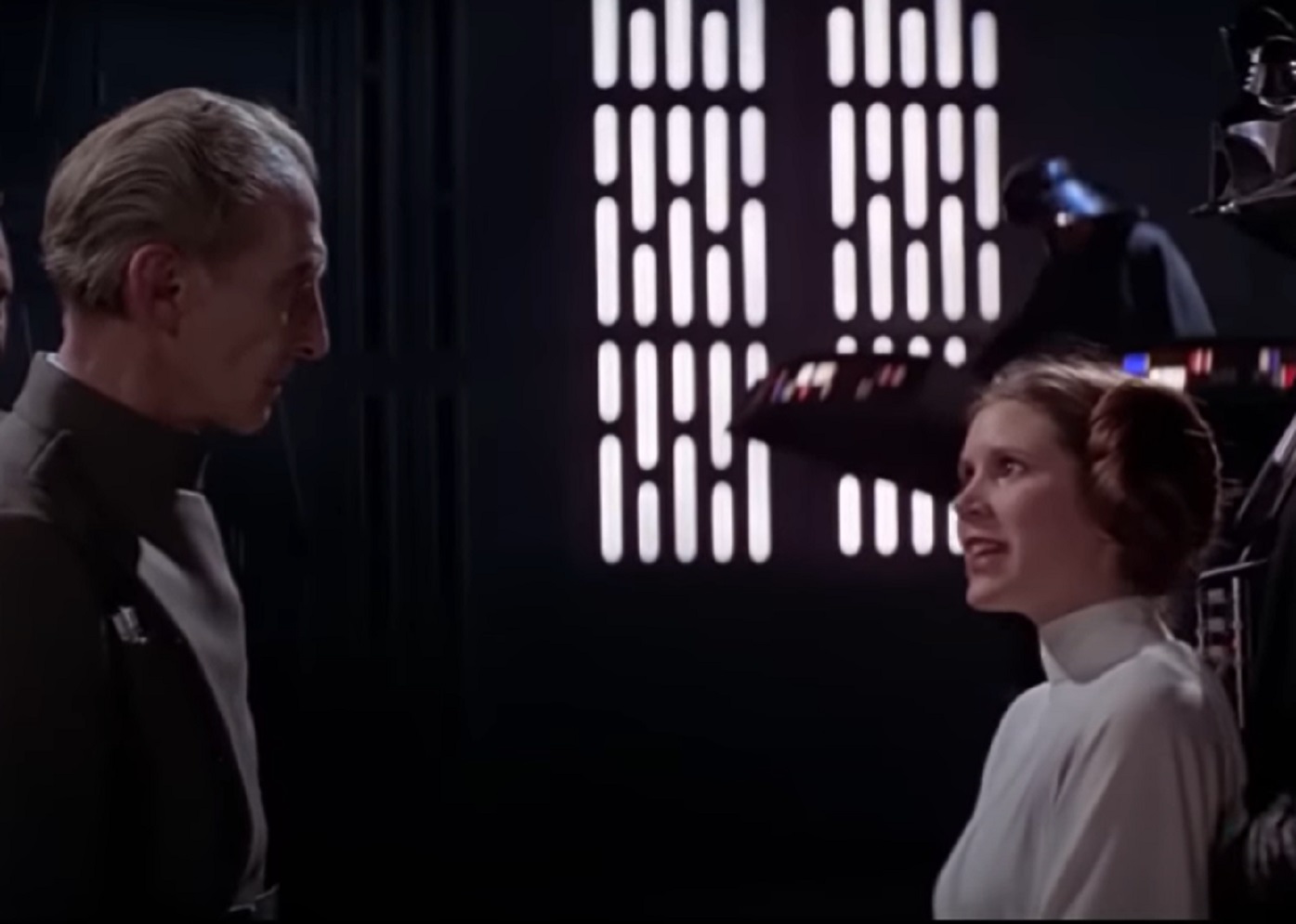 Screenshot of Peter Cushing in uniform and Carrie Fisher - from Star Wars: Episode IV (1977)