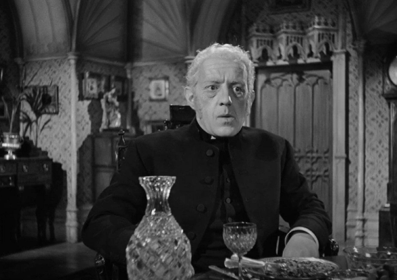 Screenshot of Alec Guinness in black clothes looking upset - from Kind Hearts And Coronets (1949)