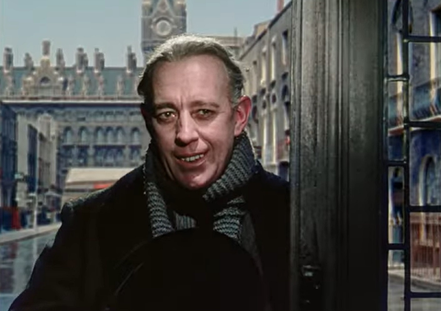 Screenshot of Alec Guinness looking at camera and smiling - from The Ladykillers (1955)