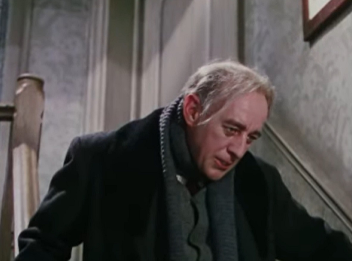 Screenshot of Alec Guinness wearing dark coat ,looking down - from The Ladykillers (1955)