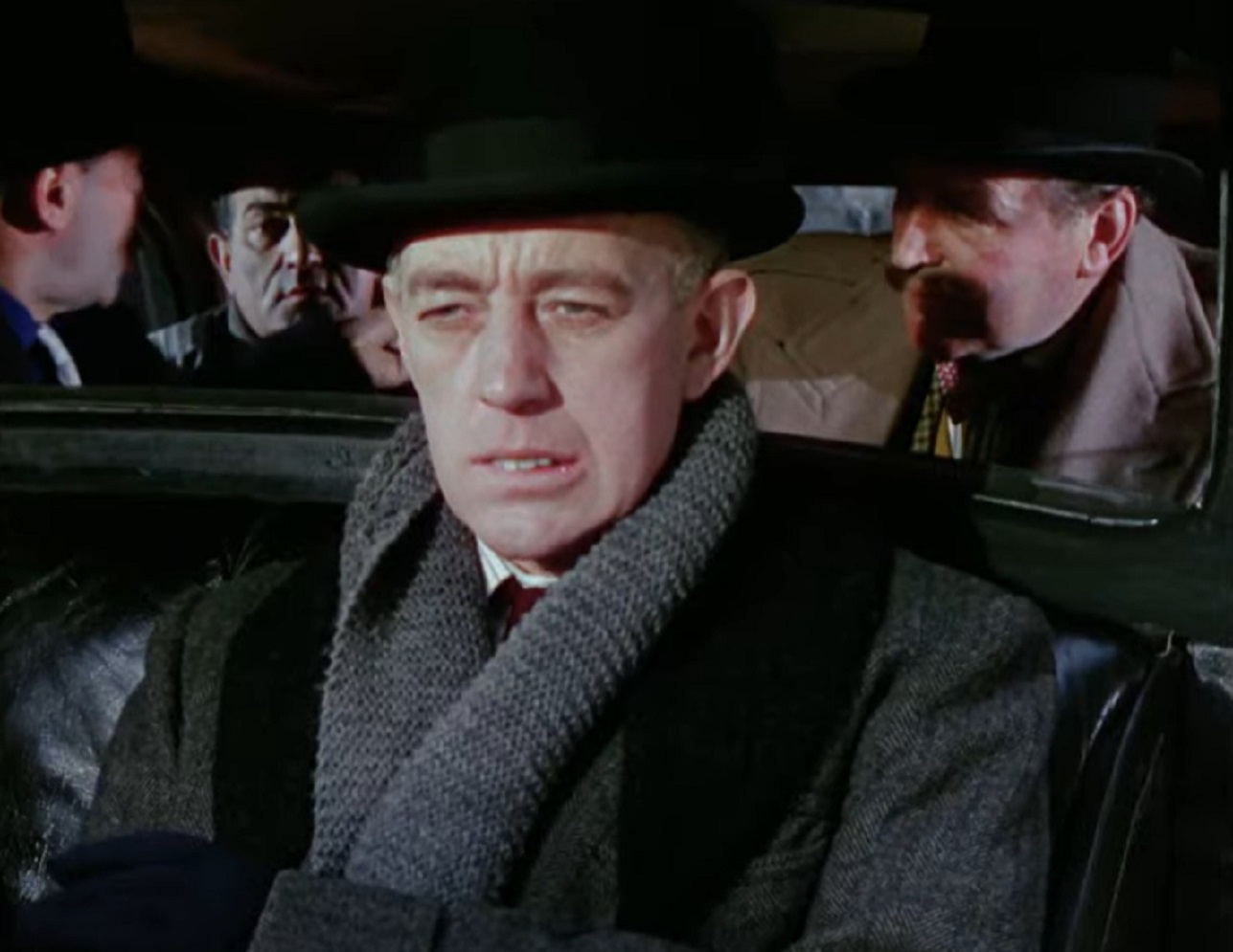 Screenshot of Alec Guinness seating in car with other people - from The Ladykillers (1955)