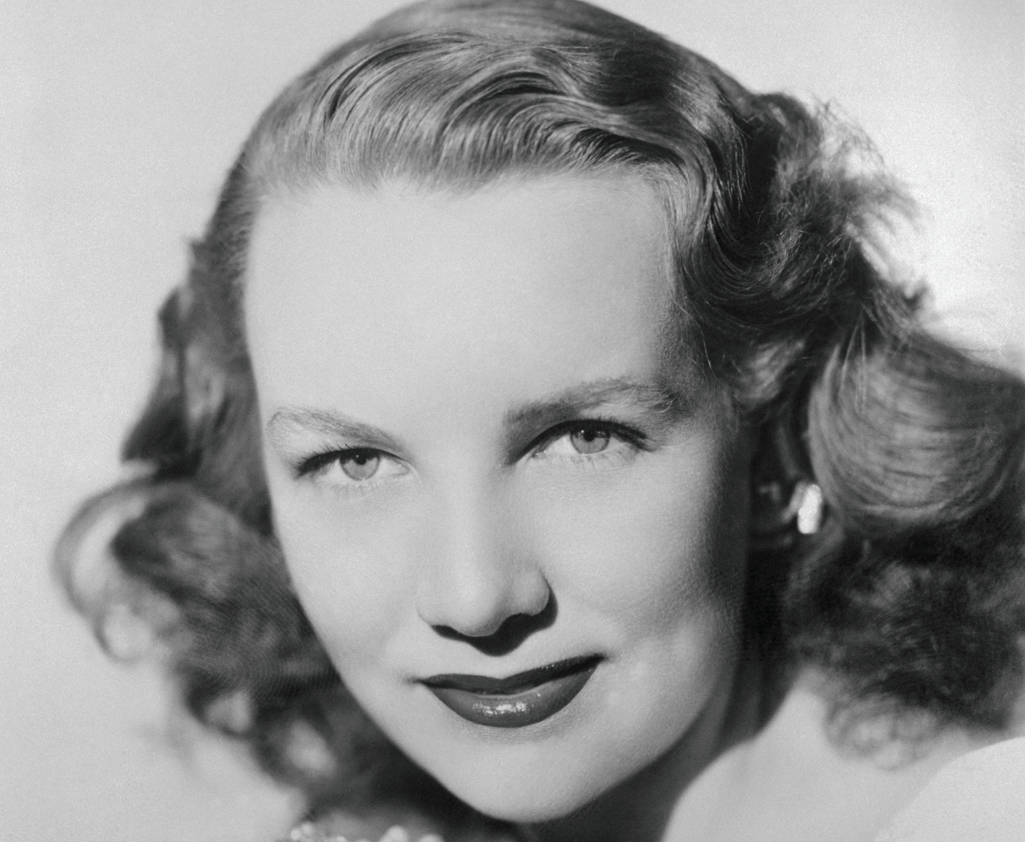 Mrs. William Woodward Jr looking at camera