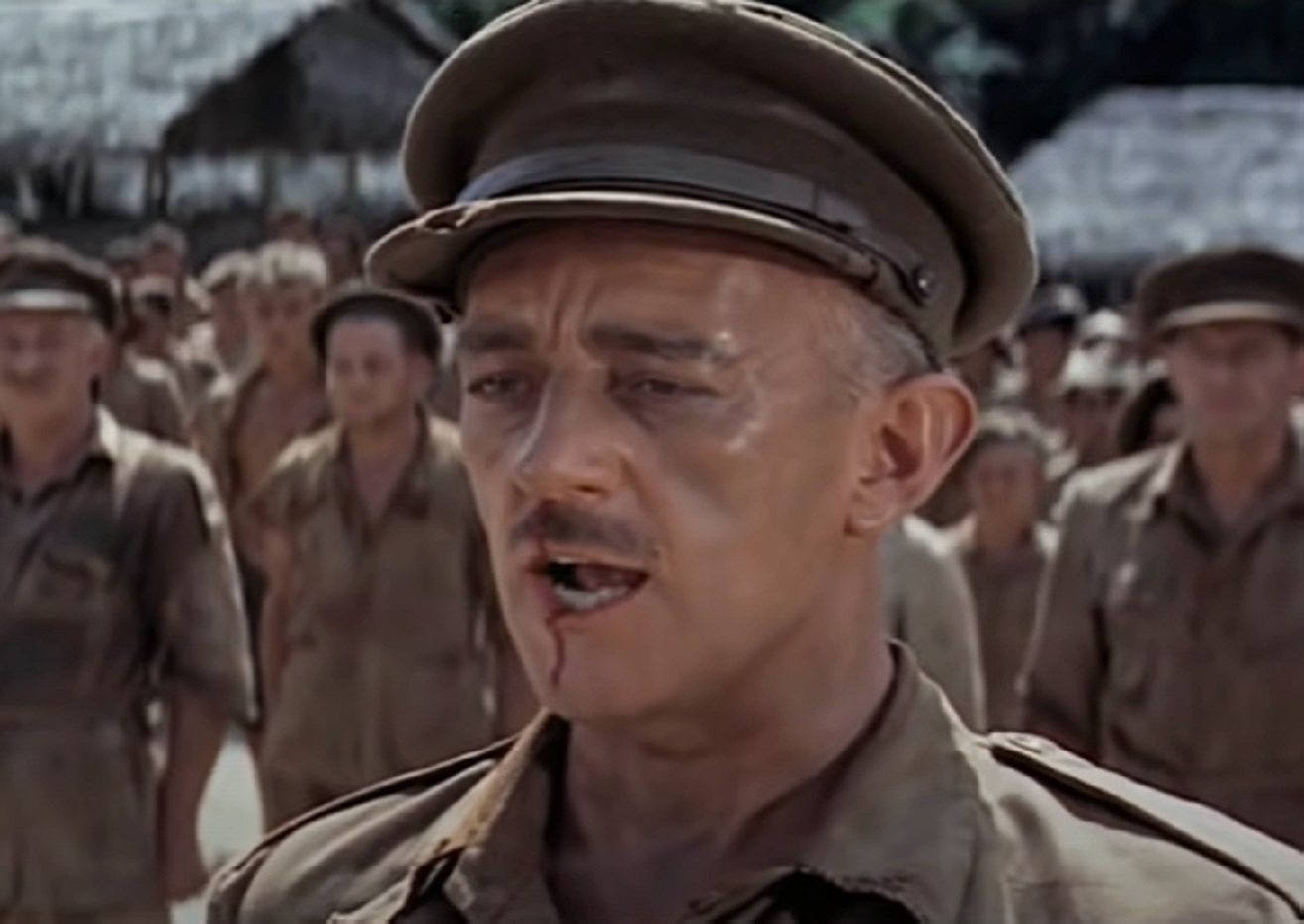 Screenshot of Alec Guinness in uniform is talking outside - from The Bridge on the River Kwai (1957)