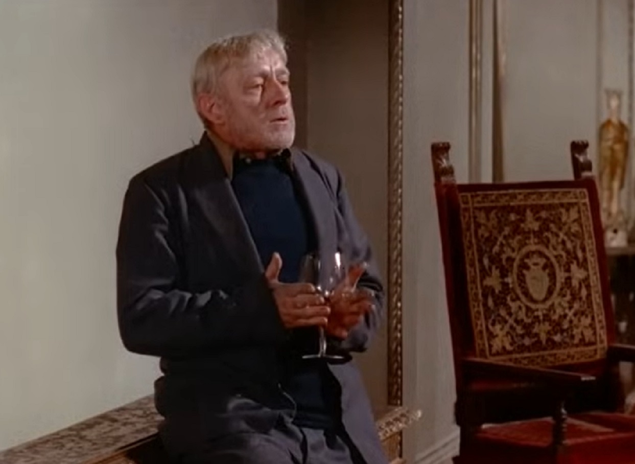 Screenshot of Alec Guinness holding a glass - from The Horse's Mouth (1958)
