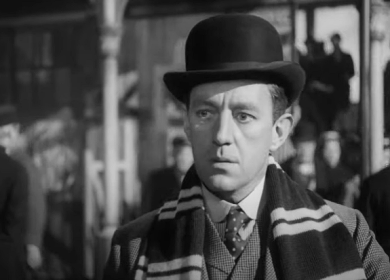 Screenshot of Alec Guinness wearing hat is looking surprised - from The Promoter (1952)
