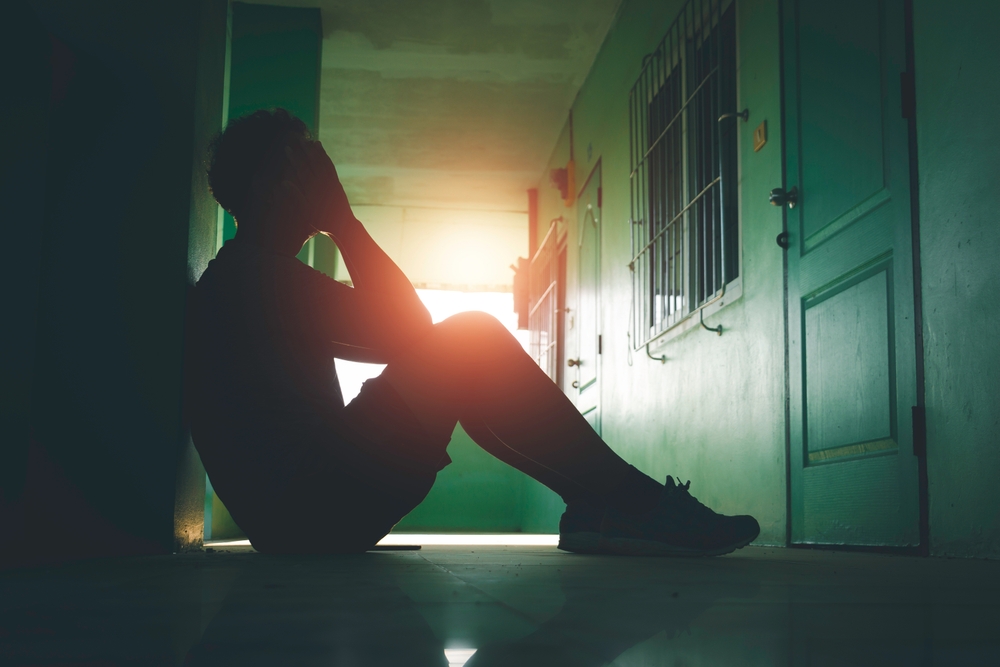 Lonely man sitting on the floor