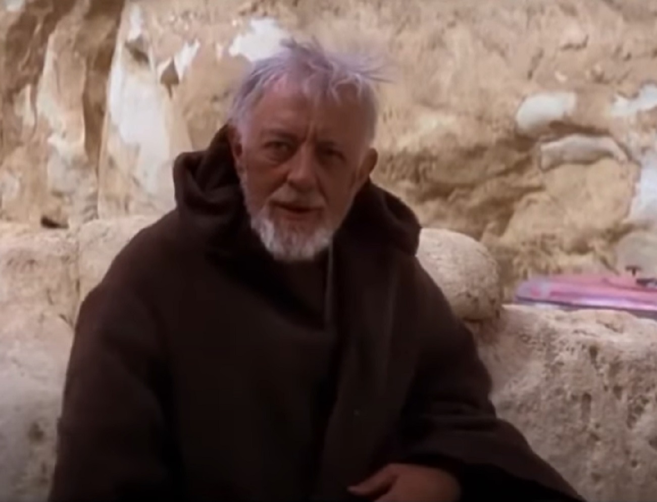 Screenshot of Alec Guinness wearing brown coat - from Star Wars: Episode IV (1977)