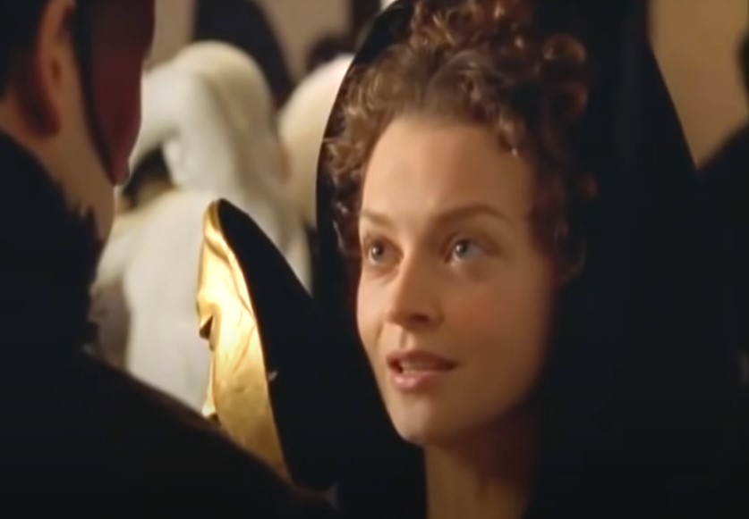 Julie Cox as Annabella Milbanke, Lady Byron  in black dress and hat speaking to Byron