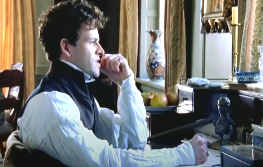  Jonny Lee Miller as Lord Byron sitting at desk