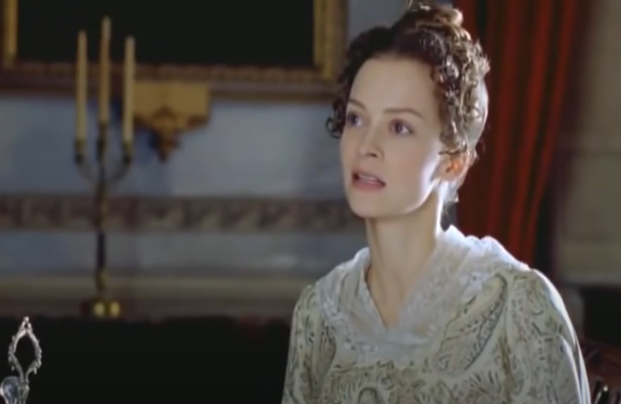 Julie Cox as Annabella Milbanke, Lady Byron  in white dress sitting at table