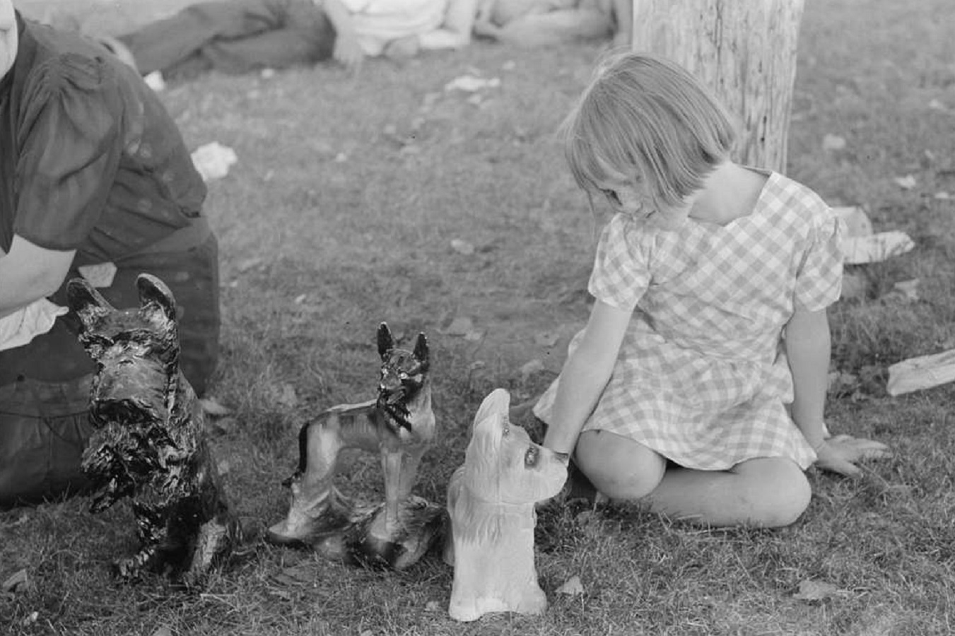 A black and white photo of a little girl playing - 1944