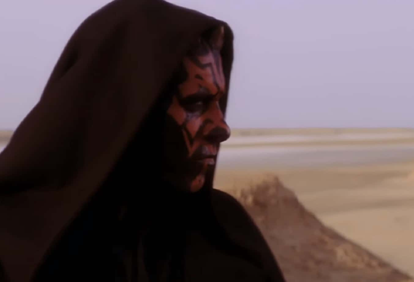 Screenshot of Dart Maul with black coat looking at side - from Star Wars: Episode I – The Phantom Menace (1999)